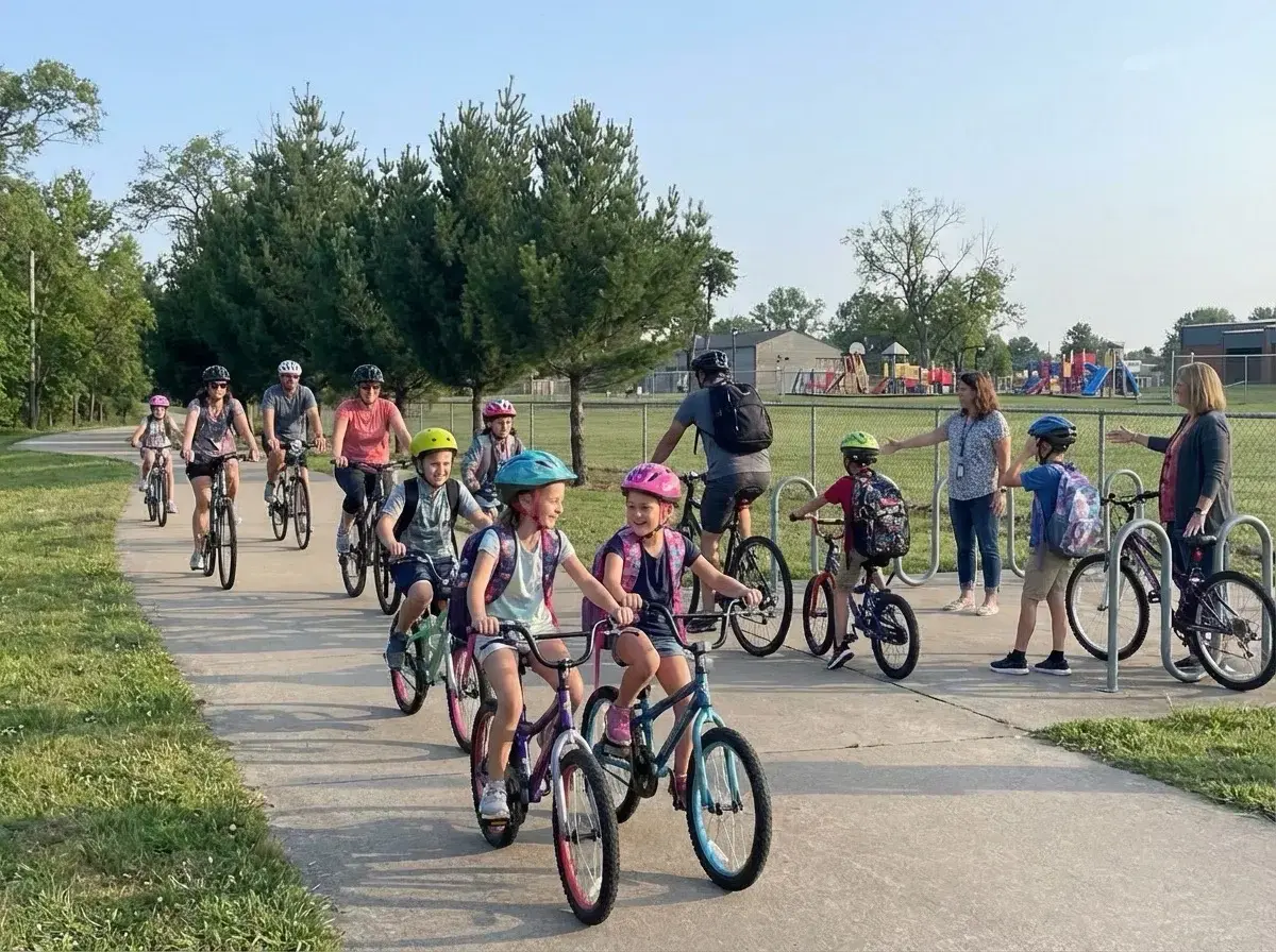 Children and parents biking together in a community bike train