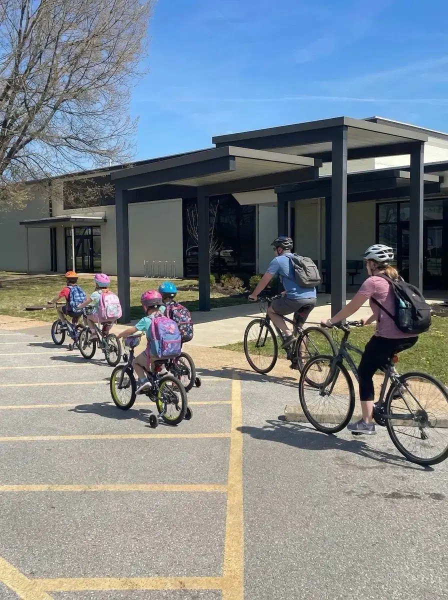 Parents and children arriving at school by bike
